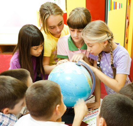 kids exploring a globe